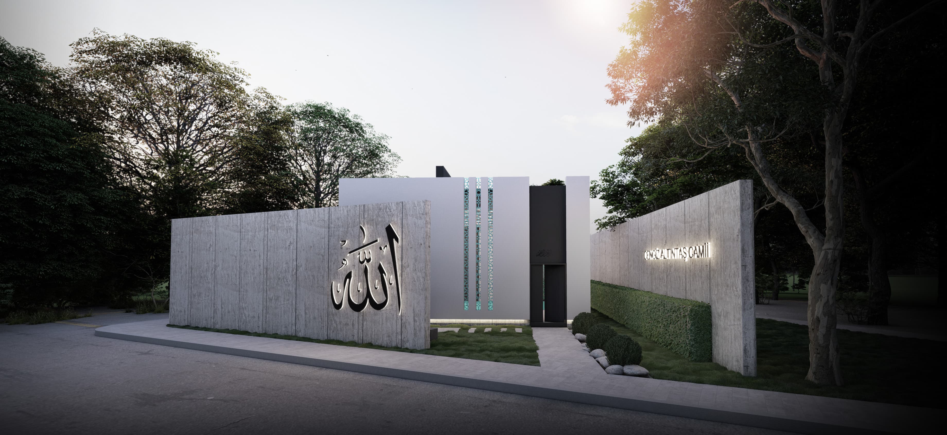 Angled view of mosque entrance with illuminated calligraphy and tree canopy