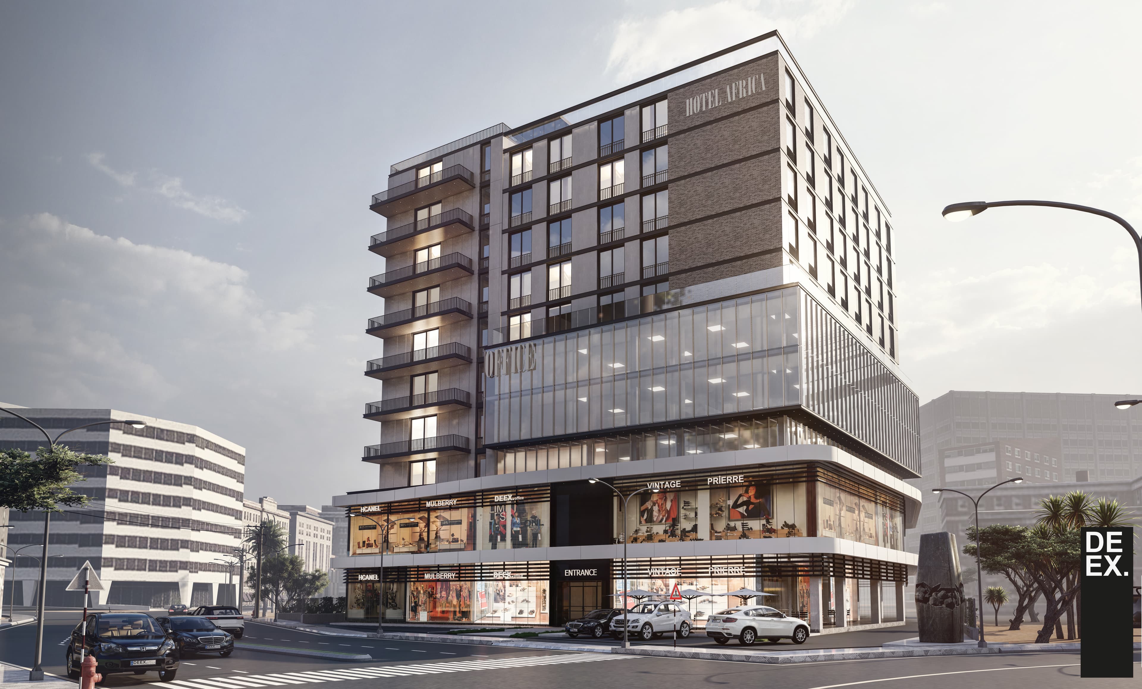 Corner view of mixed-use building with hotel signage and retail storefronts at street level