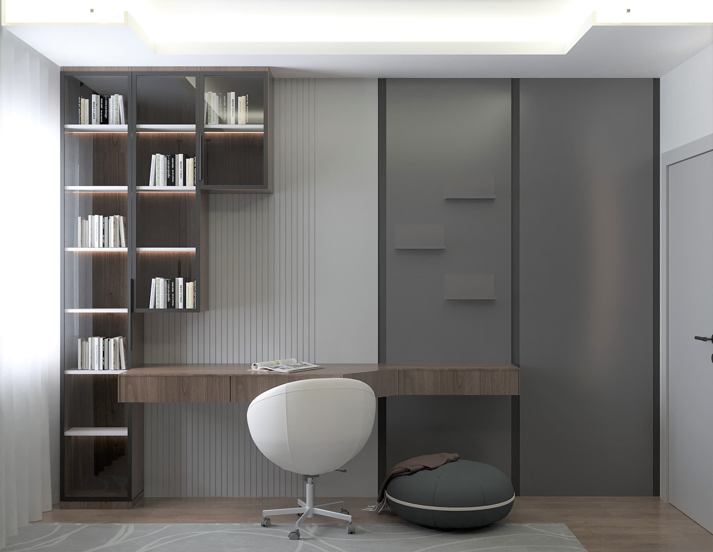 Study area with walnut desk, glass-front bookcase and white chair