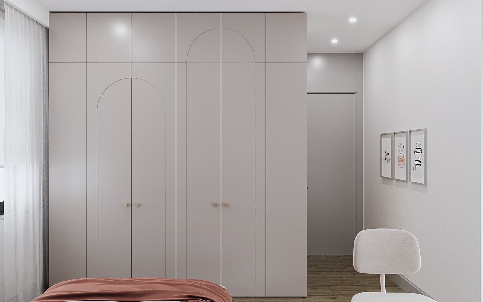 Pink arched-door wardrobe with animal art prints on the wall