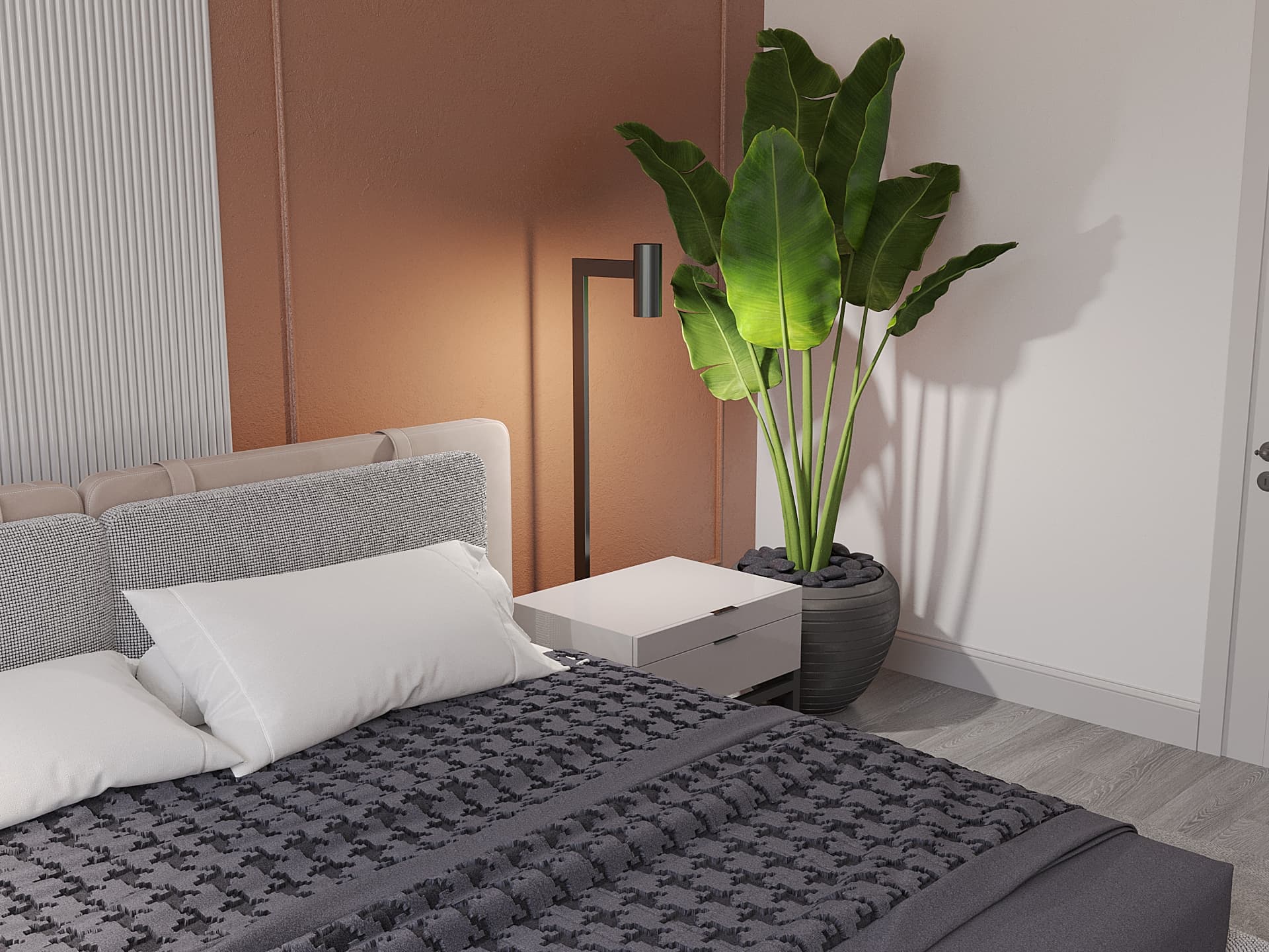 Bedside detail with terracotta headboard panel, reading lamp, and tropical plant